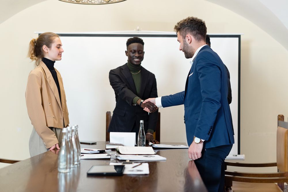 Stock photo of business professionals shaking hands after a meeting